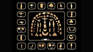 A compilation of small, gold-toned artifacts including coins and figurines of gods