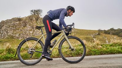 Cyclist riding in winter with a set of full length mudguards 