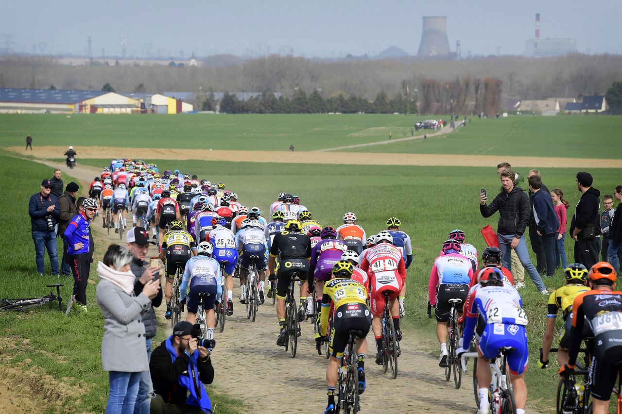 A rear view of the peloton and the cobbles of northern France