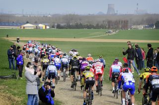 A rear view of the peloton and the cobbles of northern France