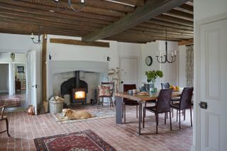 dining room with fireplace and dog