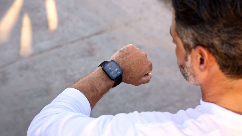 Photo of the Garmin Venu X1 on a man&#039;s wrist, showing call data and several button options.