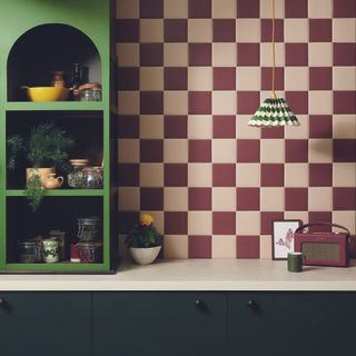 Green kitchen with red and pink checkerboard tiles