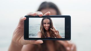Pretty lady taking a selfie with a smartphone