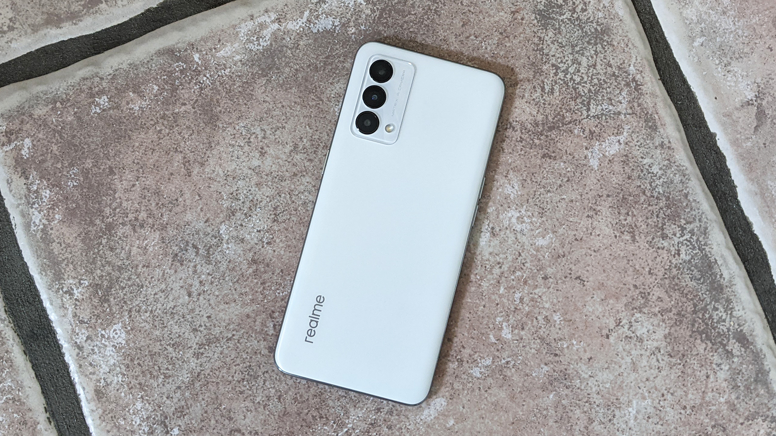 The Realme GT Master Edition face down on the floor.