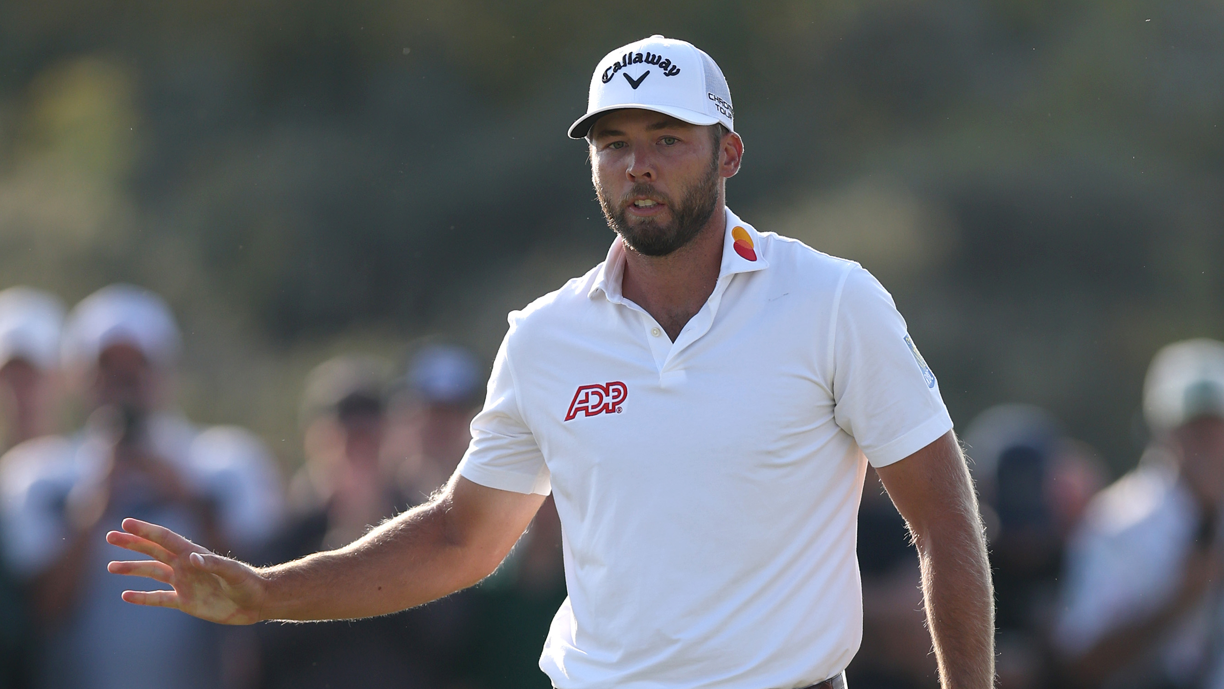 Sam Burns acknowledges the crowd at The Open
