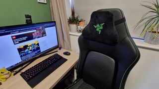 Razer Iskur V2 chair in an office space beside a desk, keyboard, monitor, and mouse