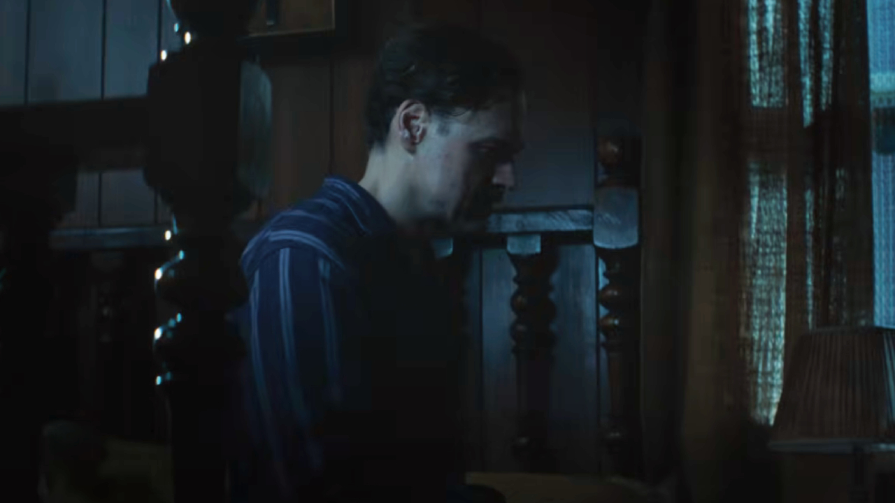 Elliot Cowan as Jack Smurl sitting up in bed in The Conjuring: Last Rites