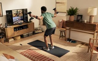 A man using Peloton Guide in his living room