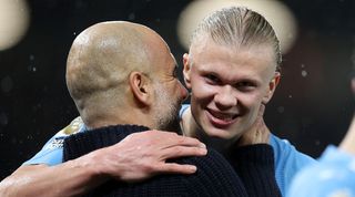 Manchester City manager Pep Guardiola embraces striker Erling Haaland after a win against Manchester United at Old Trafford in October 2023.