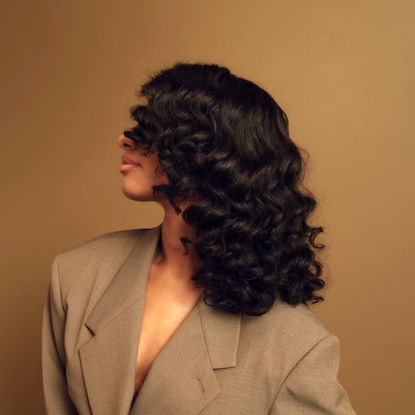 side profile of a model with curly hair