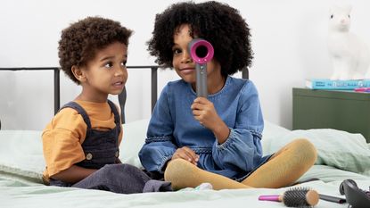 Children playing with Dyson haircare toys