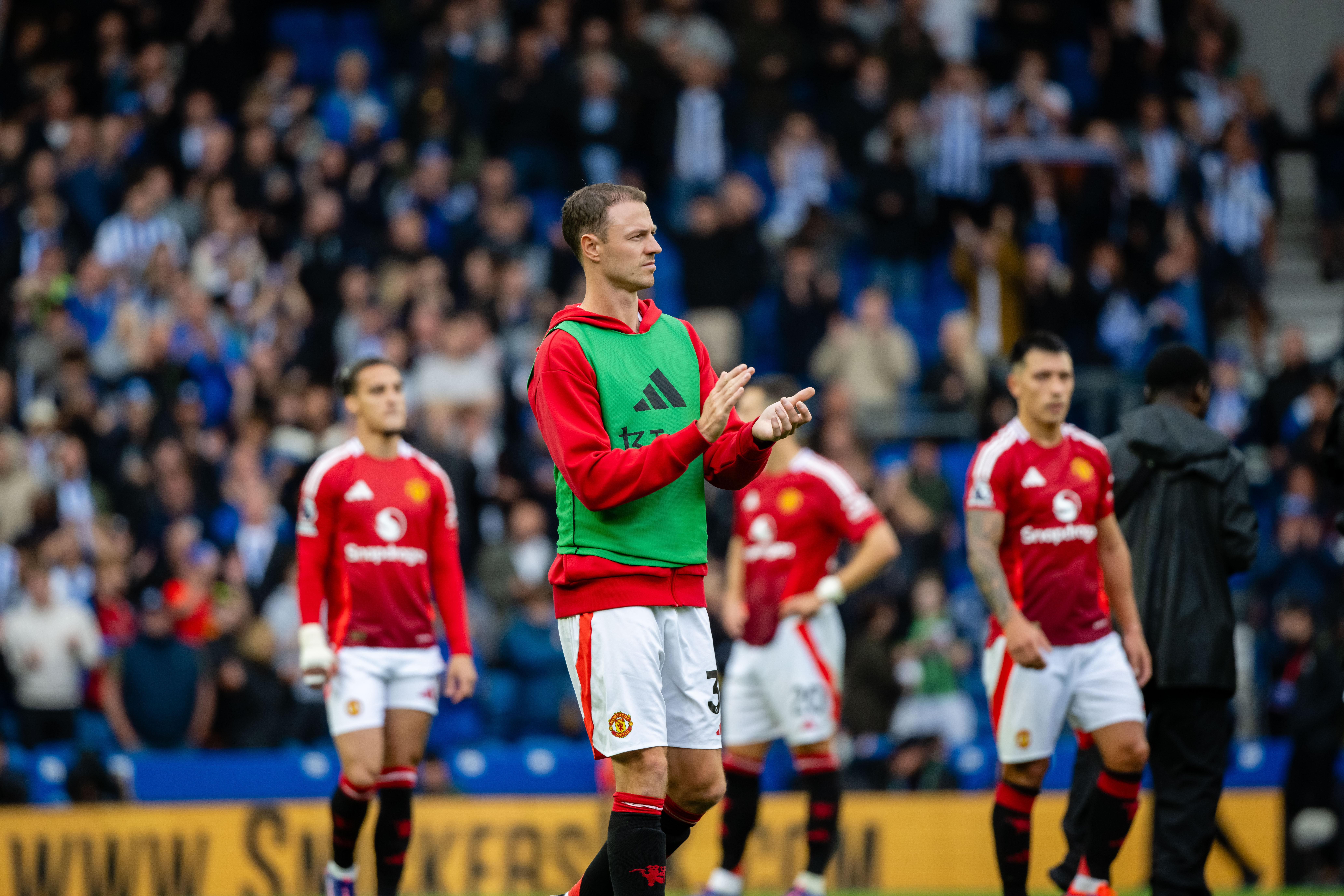 Jonny Evans applauds the Manchester United fans after a 2-1 loss to Brighton at the Amex in August 2024.