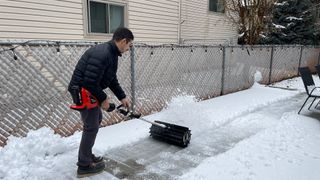 tester removing snow from patio with pro paddle attachment