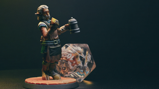 A still from the Hero Forge kickstarter for custom dice, featuring an elf and his face trapped inside a d20.