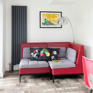 living space with red sofa with cushions