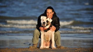 American Bulldog with owner at the beach