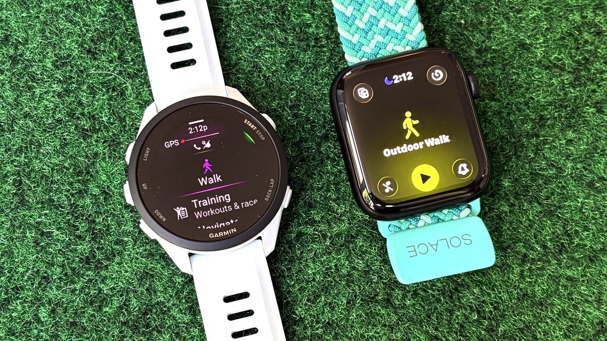 Close-up of the Apple Watch SE 3 next to the Garmin Forerunner 70