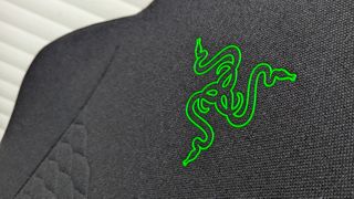 Razer Iskur V2 X gaming chair set-up outside with some Razer branded gloves! 