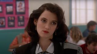 Winona Ryder in Heathers looking annoyed at someone with an angled head.
