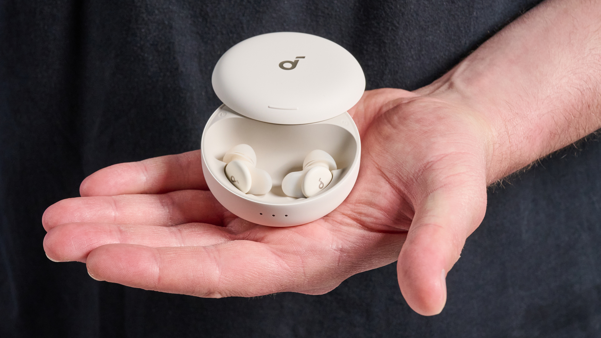 The Soundcore Sleep A30 earbuds in hand