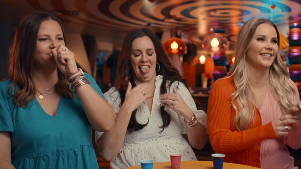 Three women getting grossed out just thinking about the red bags in Trainwreck: Poop Cruise