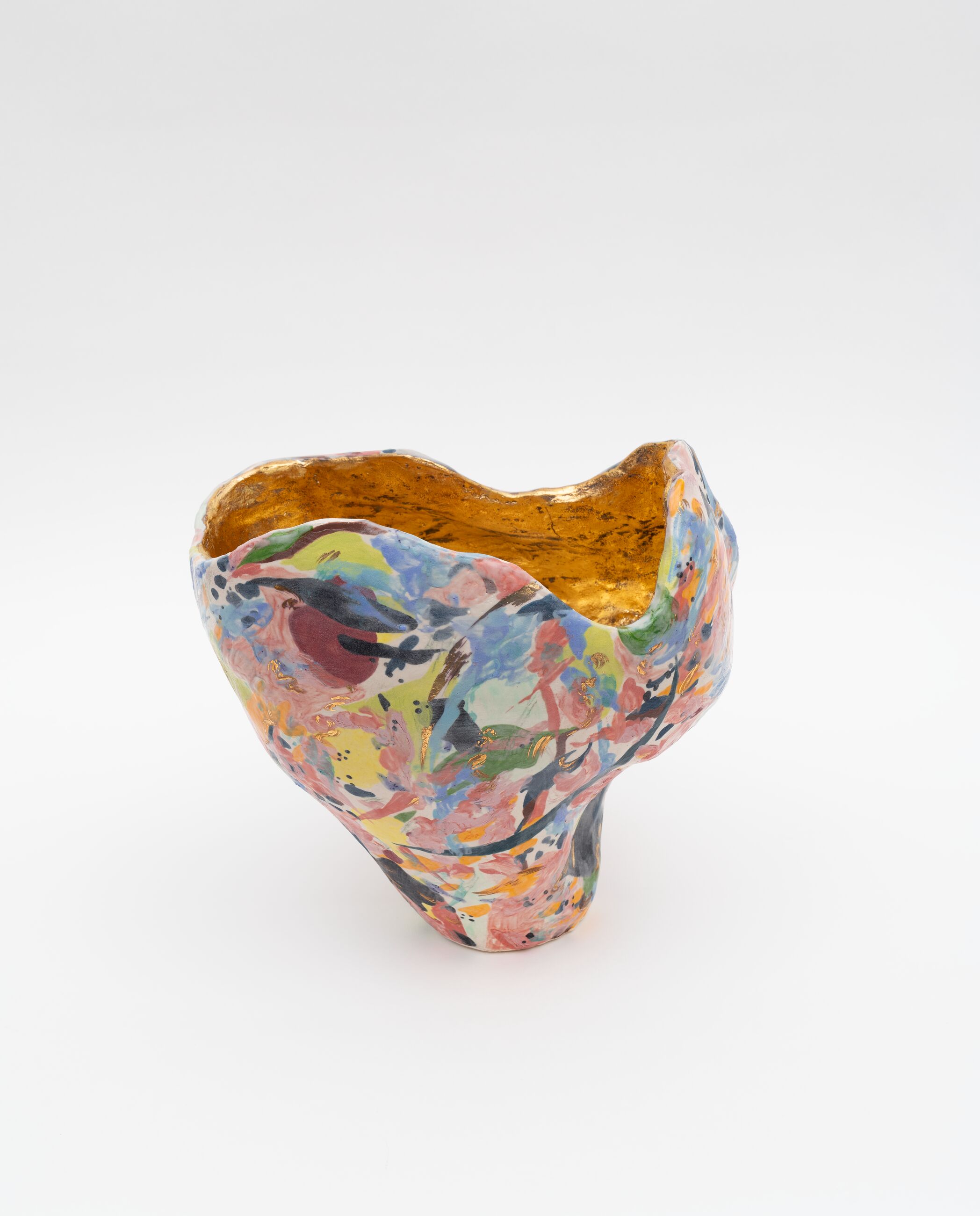 A colorful, organic shaped vase cast from painted gold.