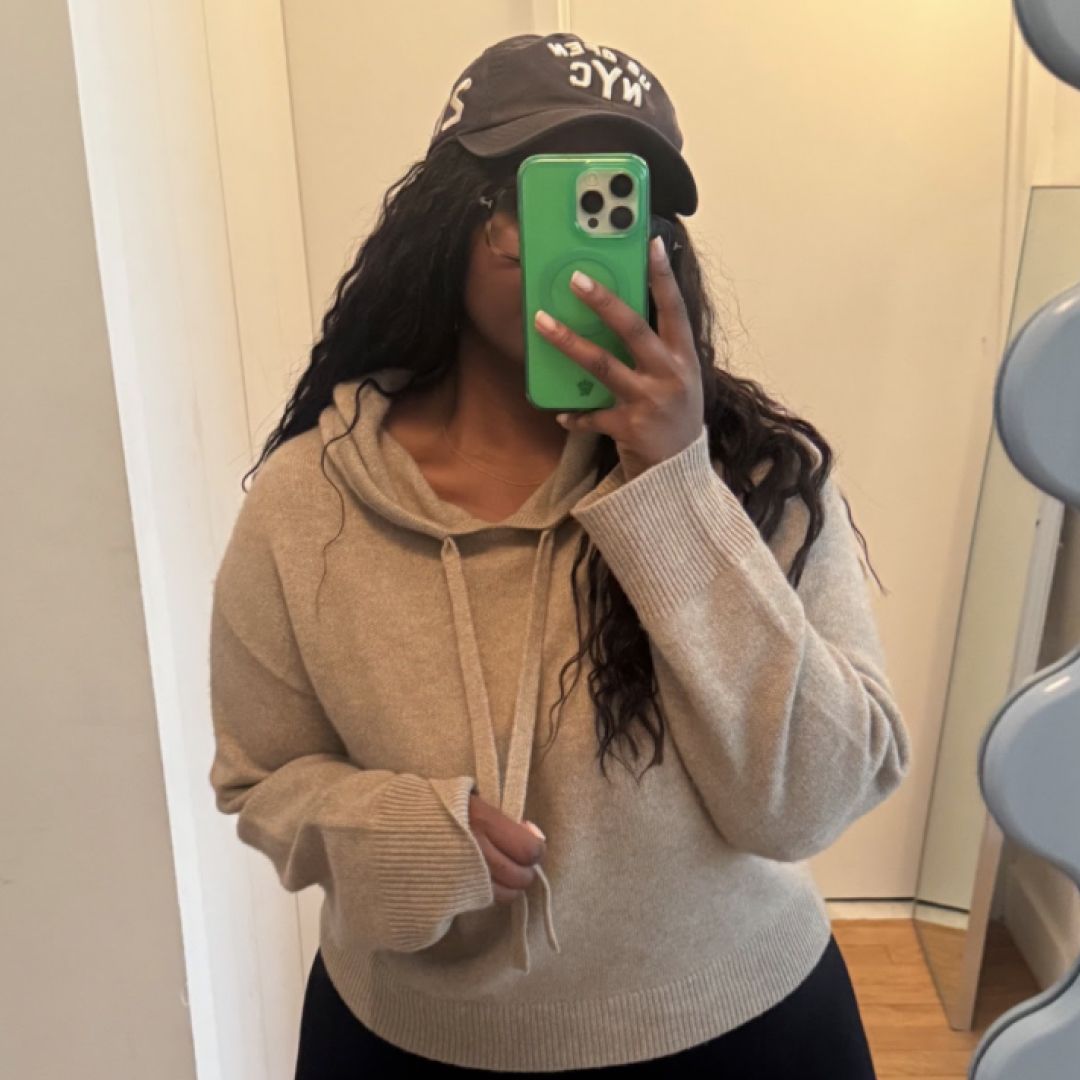 Tariro Makoni wearing a guest in residence sweatshirt with black pants