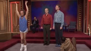 Richard Simmons posing as a tree next to Colin Mochrie, Ryan Stiles, and Wayne Brady on Whose Line Is It Anyway?