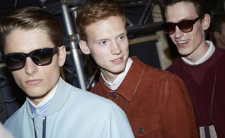 Close up of 3 male models wearing sunglasses, stood in a line