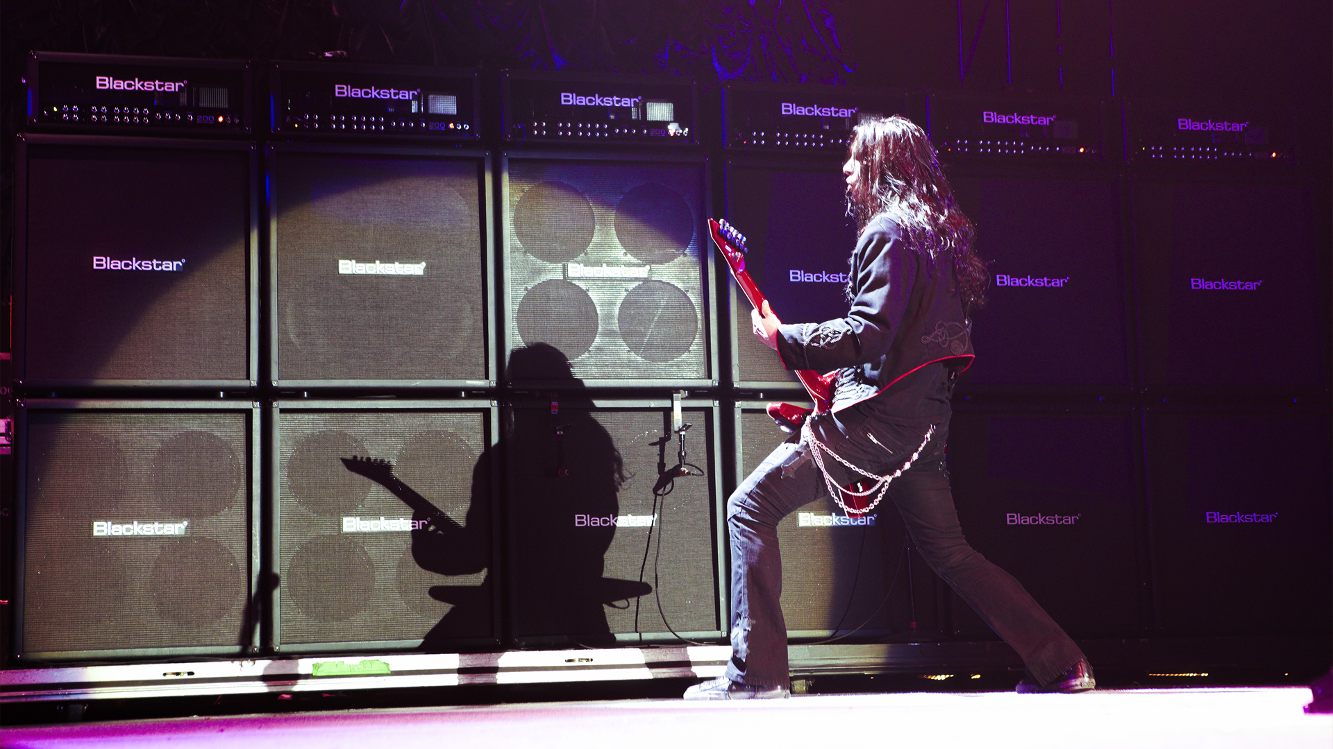 Gus G in front of Blackstar stacks