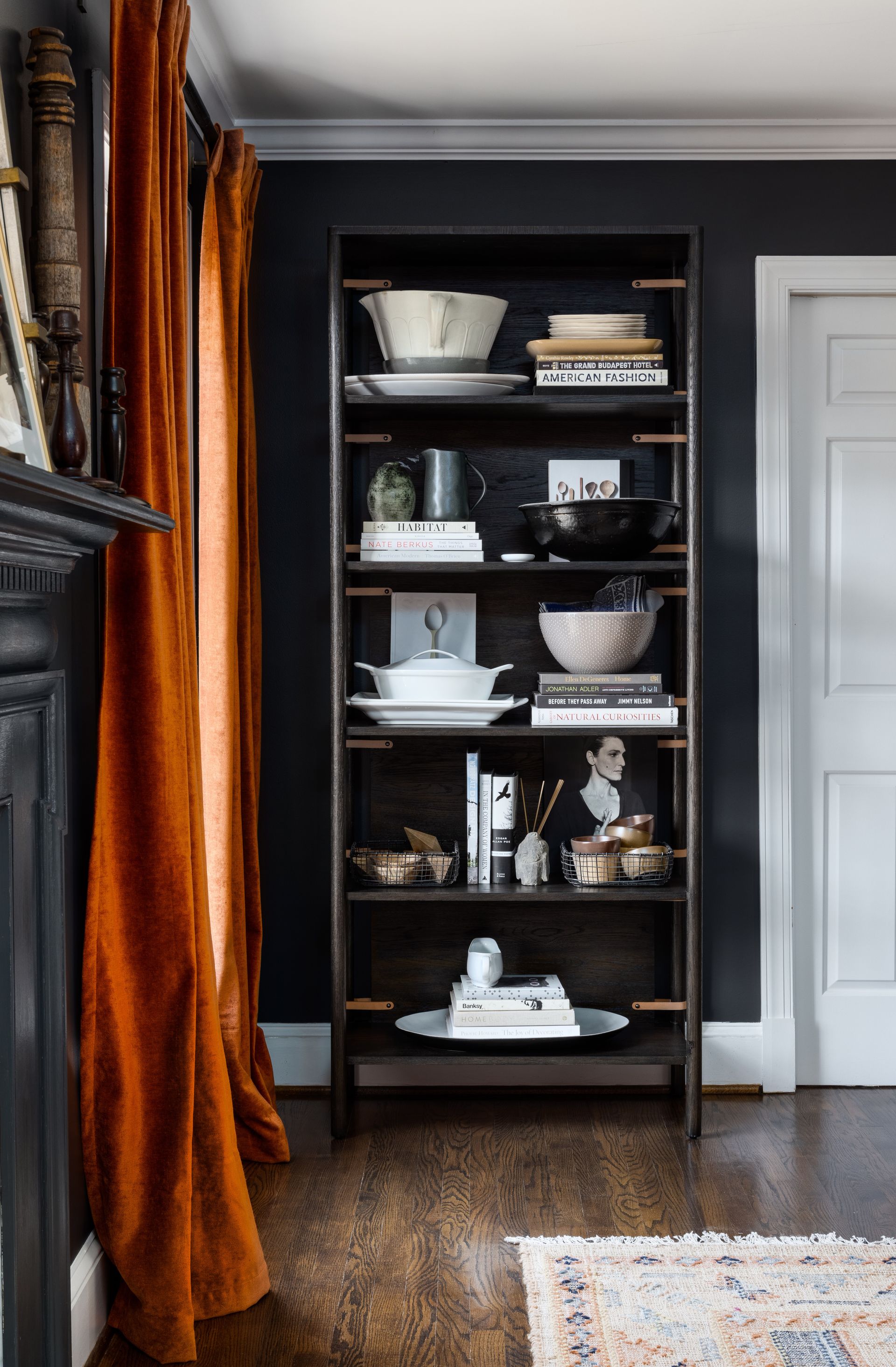 Dark dining room with shelving filled with plates
