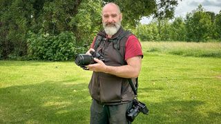 Sean McCormack in a field wearing his photo vest