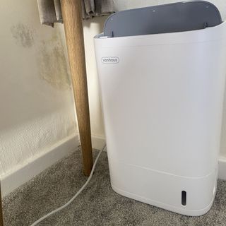 Vonhaus dehumidifier next to damp wall