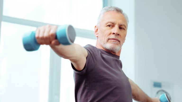 Older man lifting weights to help lose weight and increase metabolism