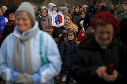 People honor the victims of the Paris attack in Boston.