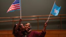 MINNEAPOLIS, MN. - DECEMBER 2022: Mano Ali held her daughter, Iqra, 8, as they waved flags together while waiting for Somali President Hassan Sheikh Mohamud to arrive Thursday night, December 15, 2022 in the auditorium of the Minneapolis Convention Center. Somali President Hassan Sheikh Mohamud is in town to address the members of the Somali community, the largest outside Africa, after attending the U.S. - Africa Leaders Summit in Washington, D.C. this week. (Photo by Jeff Wheeler/Star Tribune via Getty Images)