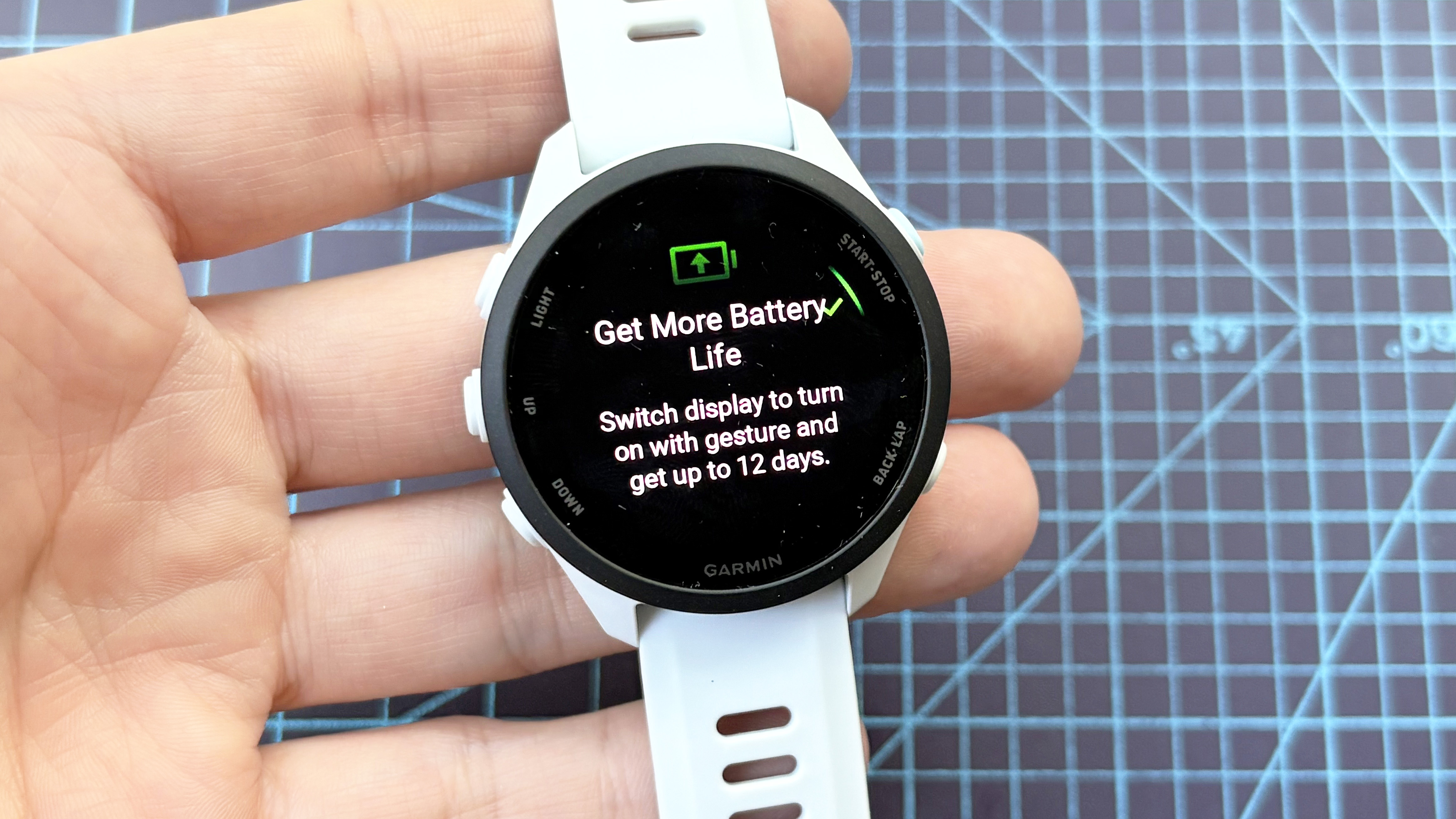 Close-up of the Garmin Forerunner 70 entry-level running watch in white