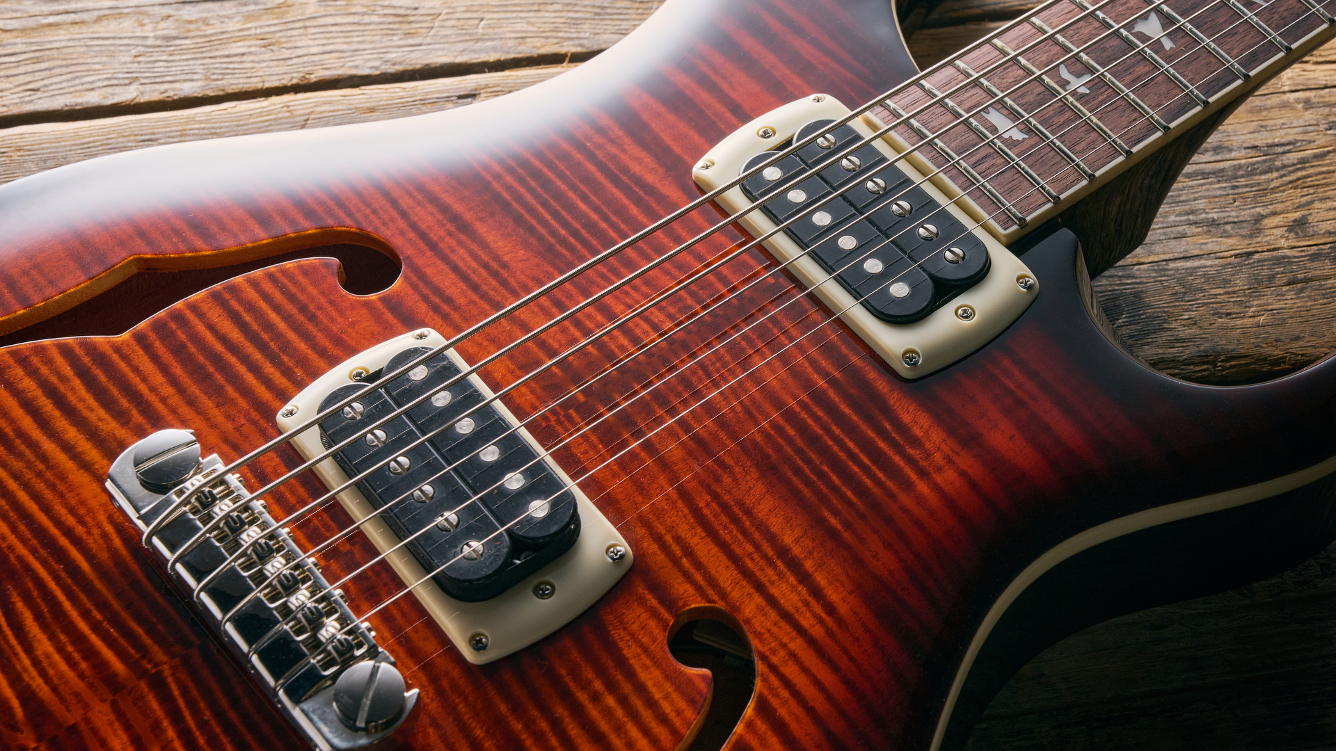 Close up of the body and dual humbuckers of ⁤the PRS SE Ed Sheeran Hollowbody I Piezo Baritone guitar