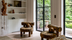 two chairs with an amber and black print fabric