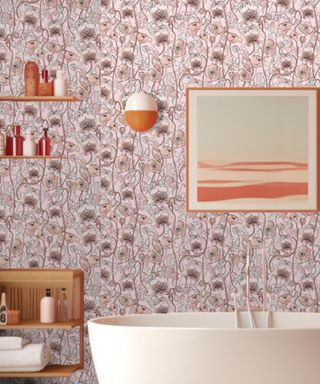 A bathroom with purple floral wallpaper, wooden wall shelves, a blue and orange framed print, and a white bath tub