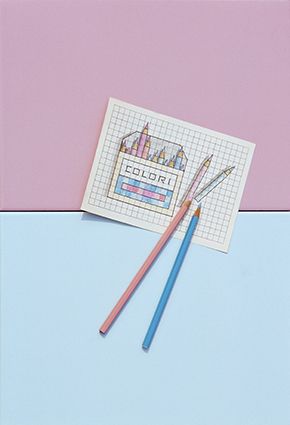 Pink and light blue tiles with a squared paper and pencils, photographed by Luigi Ghirri for Marazzi
