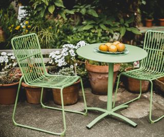green garden furniture in a small garden