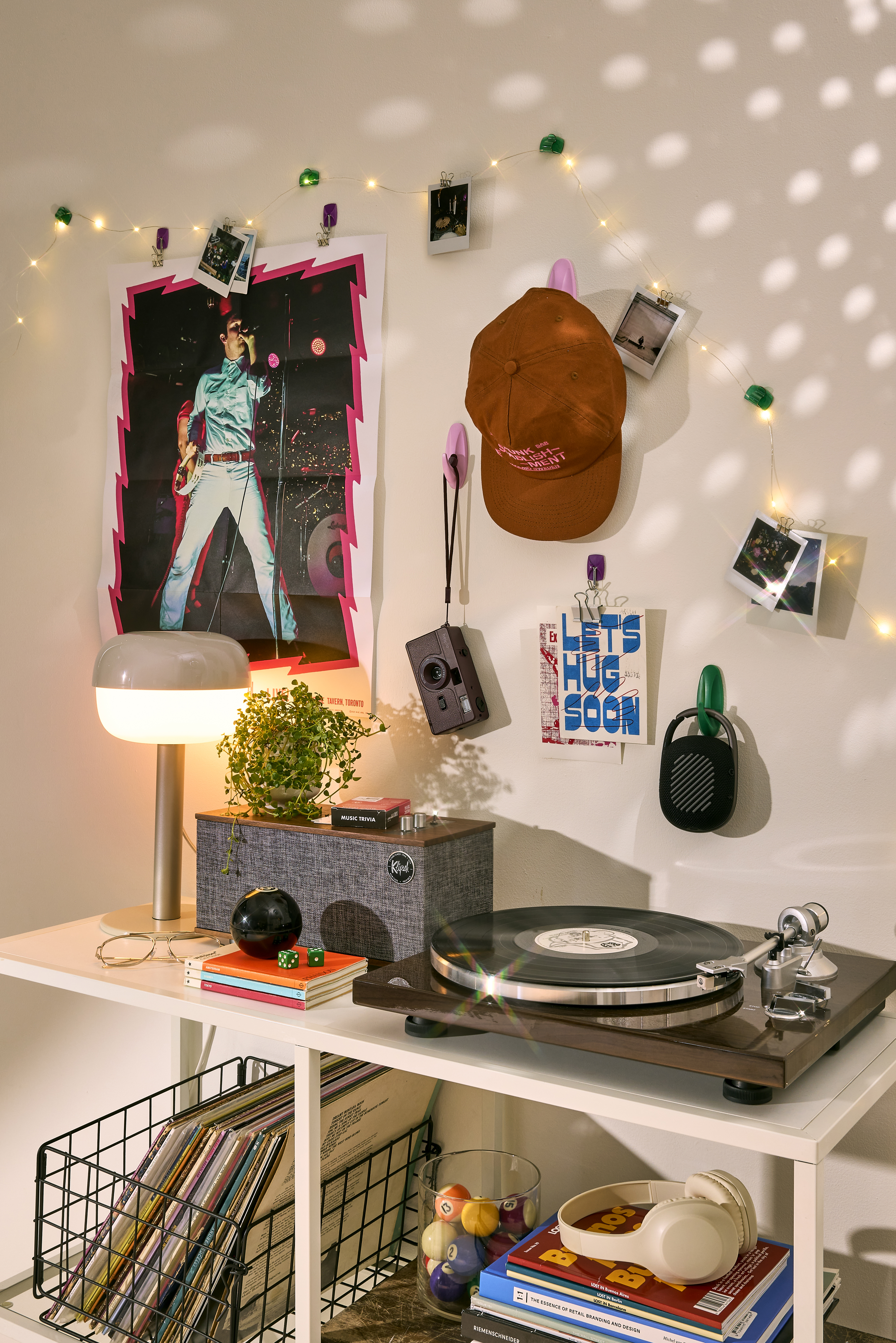 Dorm room with vinyl record player, a modern table lamp, and disco lights