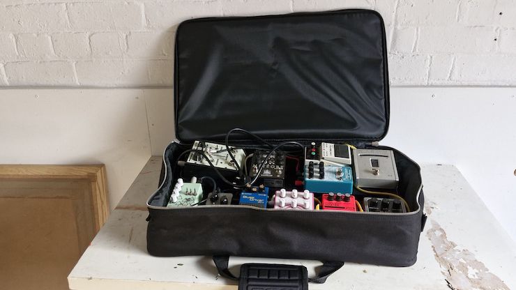 A Pedaltrain Classic 1 pedalboard with pedals in its included case