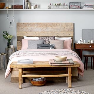 bedroom with grey wall and wooden bed