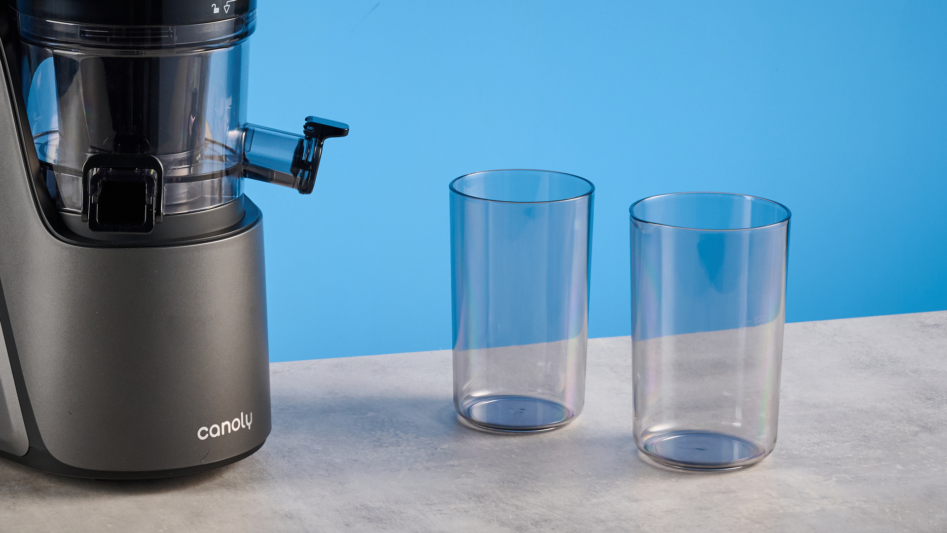 Canoly C16 Cold Press Juicer photographed in front of a blue background