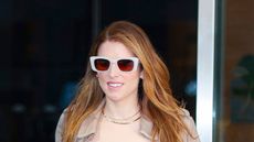 Anna Kendrick wearing sunglasses and trench