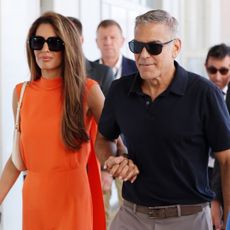 Amal Clooney departs the 81st Venice Film Festival with husband George Clooney.