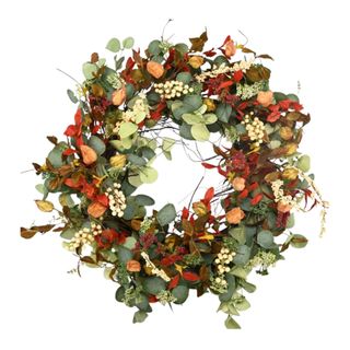 A fall wreath with orange, red, and green leaves and cream berries